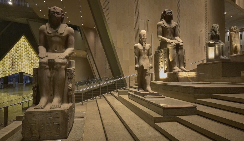Interior of the Grand Egyptian Museum hall with statues