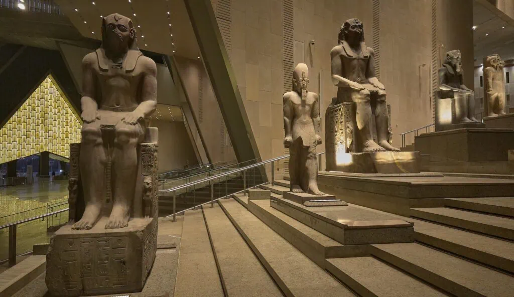 Interior of the Grand Egyptian Museum hall with statues