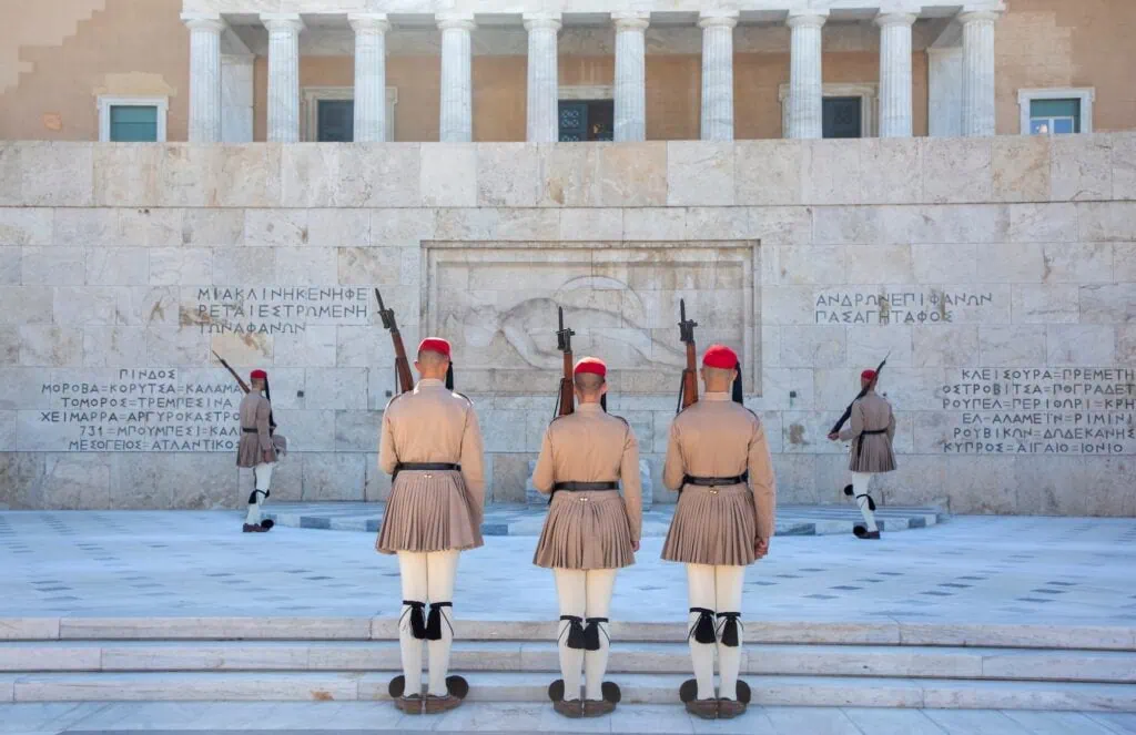 Tomb of the Unknown Soldier at Syntagma Square with two Evzones guards in traditional uniform during the ceremonial guard