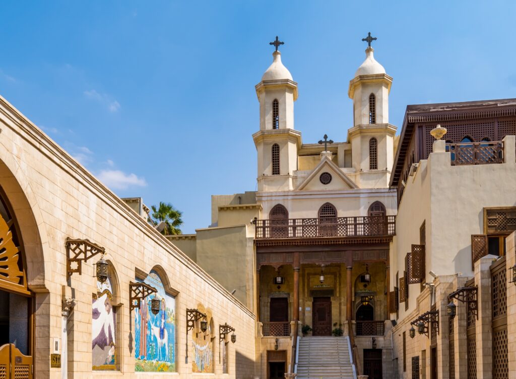 Exterior view of the Hanging Church with elevated stone structure and arched façade in Coptic Cairo, Hanging Church, Cairo