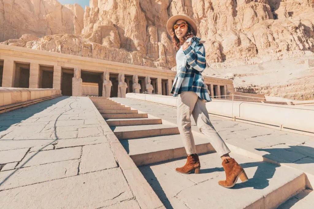 Woman walking up the stone stairways leading to the Temple of Hatshepsut, Luxor