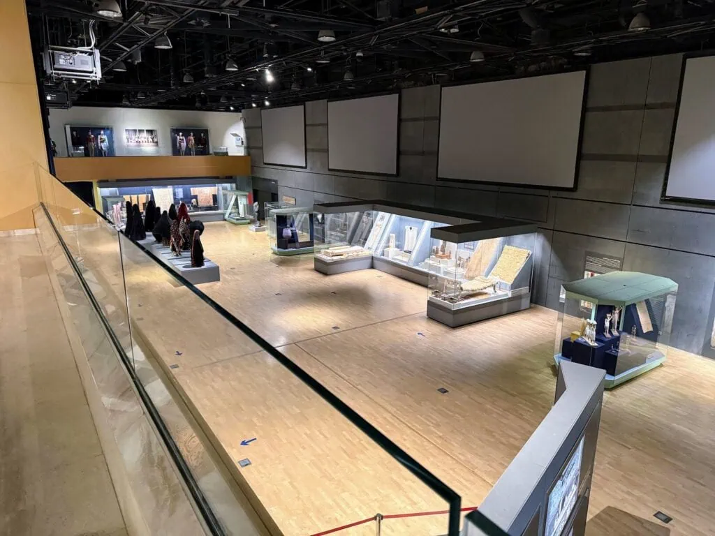Wide view of exhibition halls with artifact displays at the National Museum of Egyptian Civilization