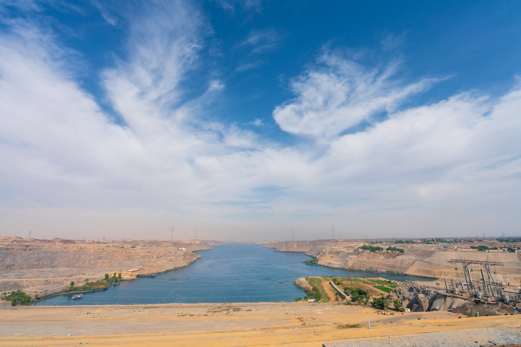 Aerial view of Aswan High Dam with Lake Nasser extending into desert landscape