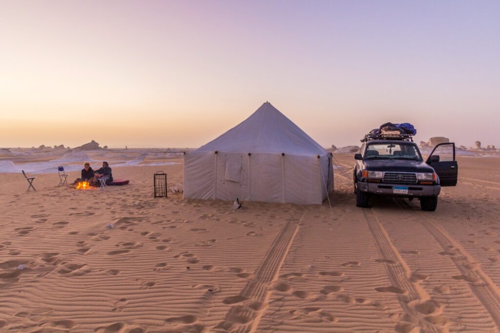 Desert camping tents set among white limestone rock formations in the White Desert, Farafra