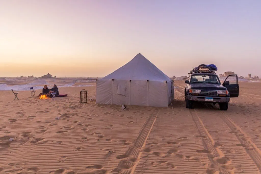 Desert camping tents set among white limestone rock formations in the White Desert, Farafra