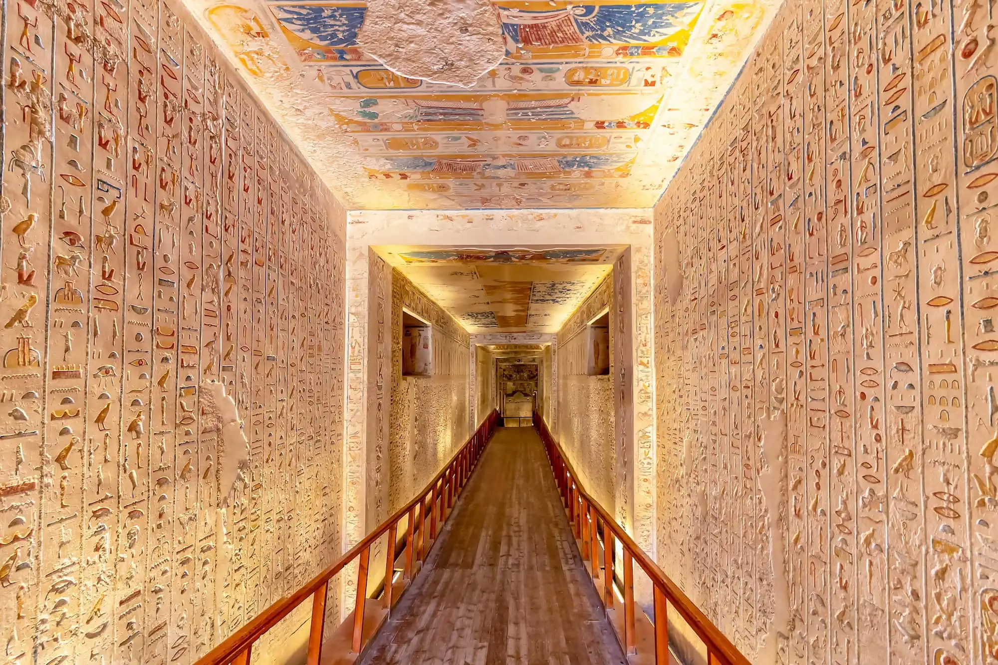 Interior of ancient Egyptian tomb in Valley of the Kings with hieroglyphic paintings and decorated ceiling