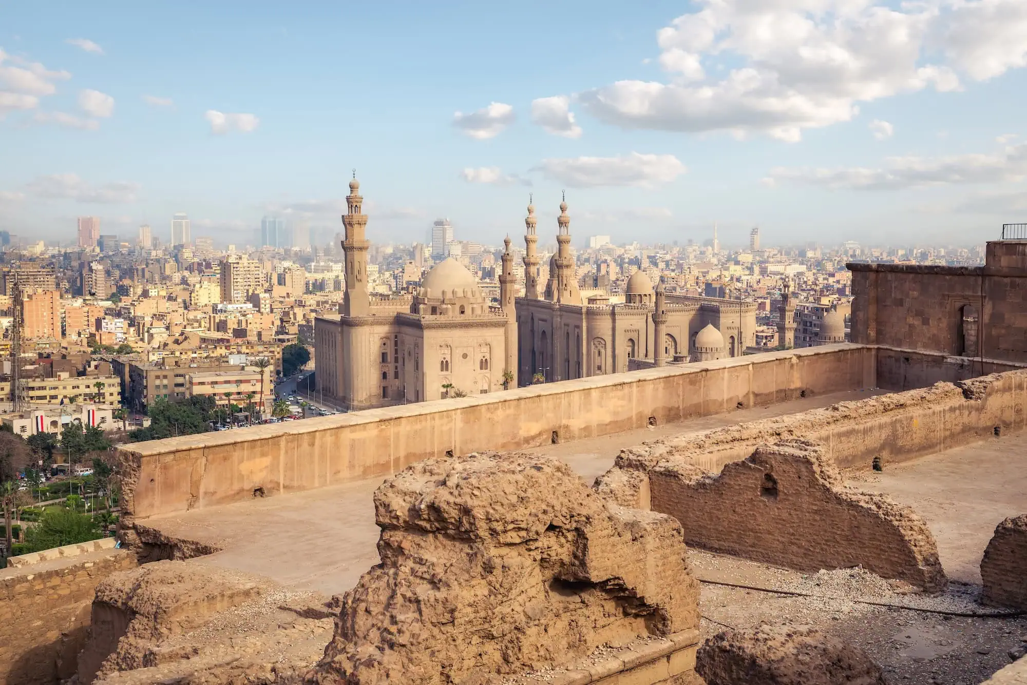 Historic Islamic architecture in Cairo showing Sultan Hassan Mosque with distinctive domes and minarets