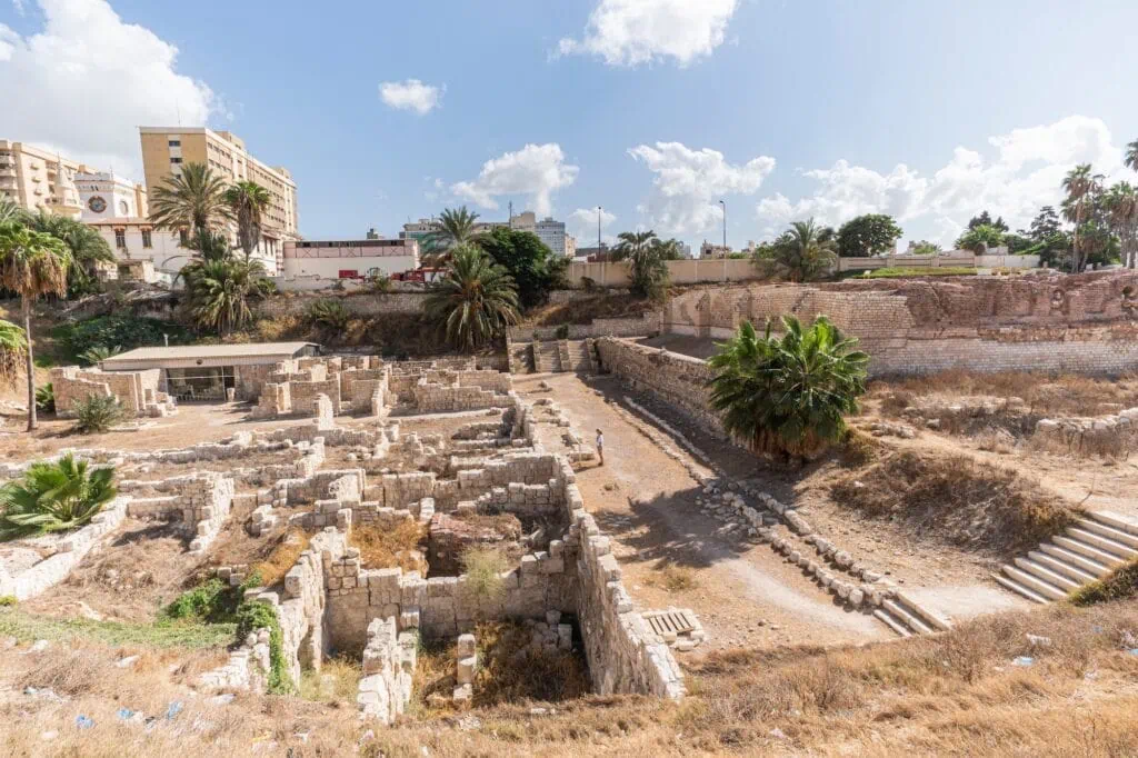 Ancient Roman stone columns and excavated ruins displayed under the open sky, Roman Amphitheatre, Alexandria