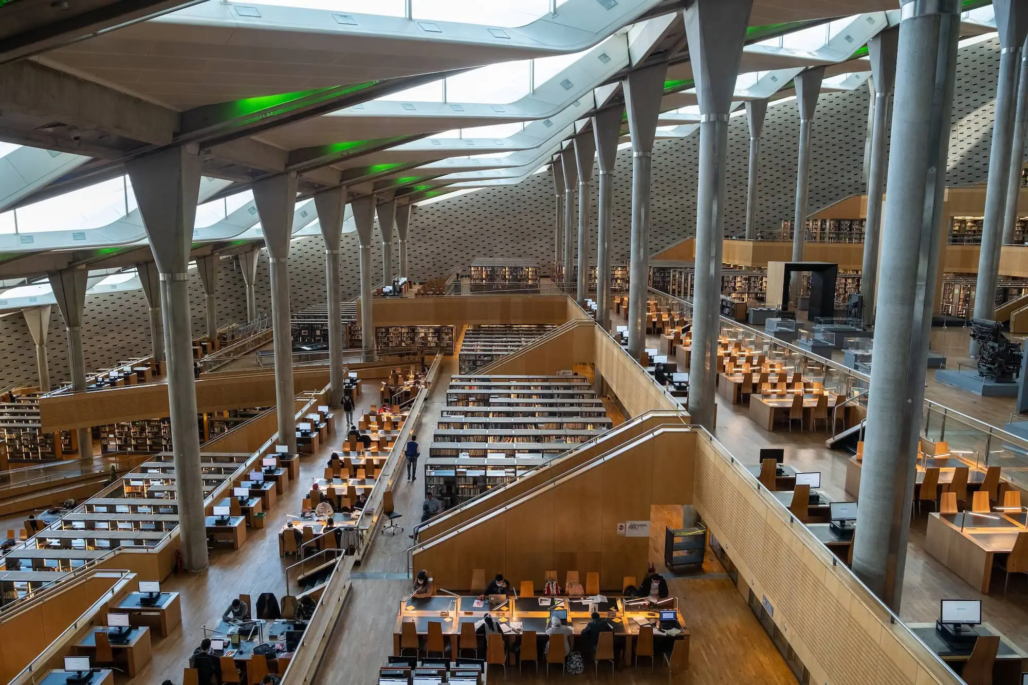 Interior of Bibliotheca Alexandrina showing terraced reading areas and geometric ceiling