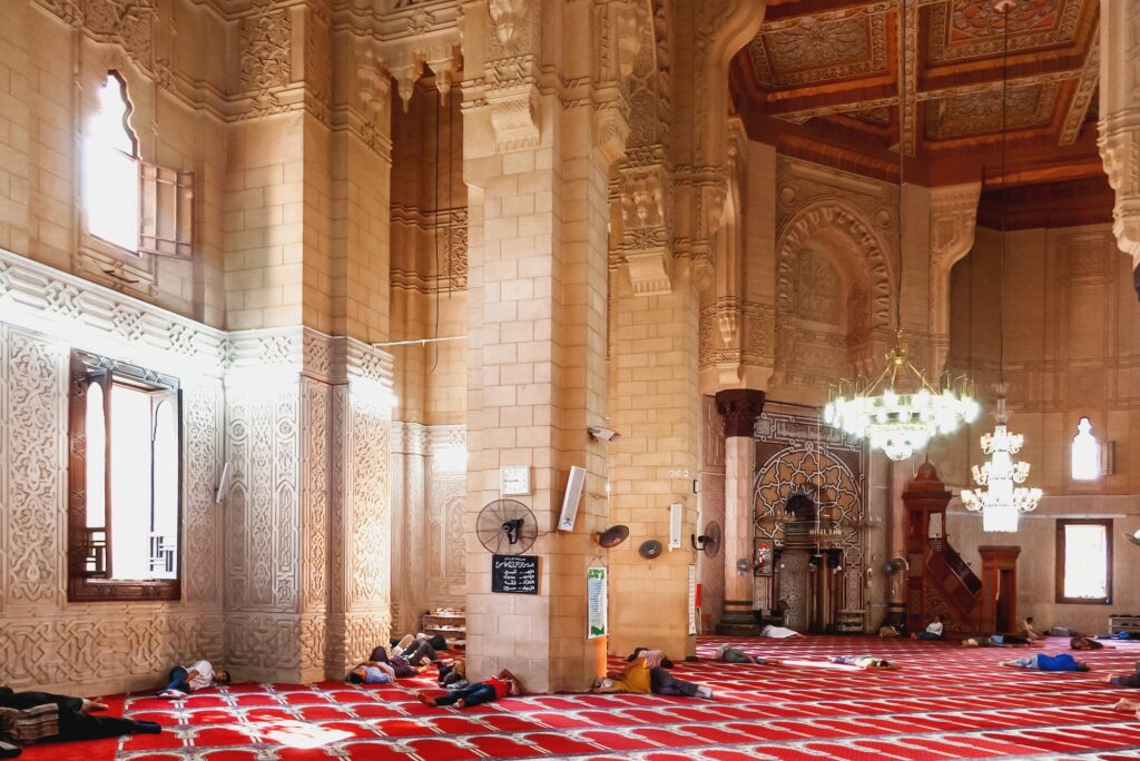 People resting on the floor inside Abu al-Abbas al-Mursi Mosque prayer hall, Alexandria