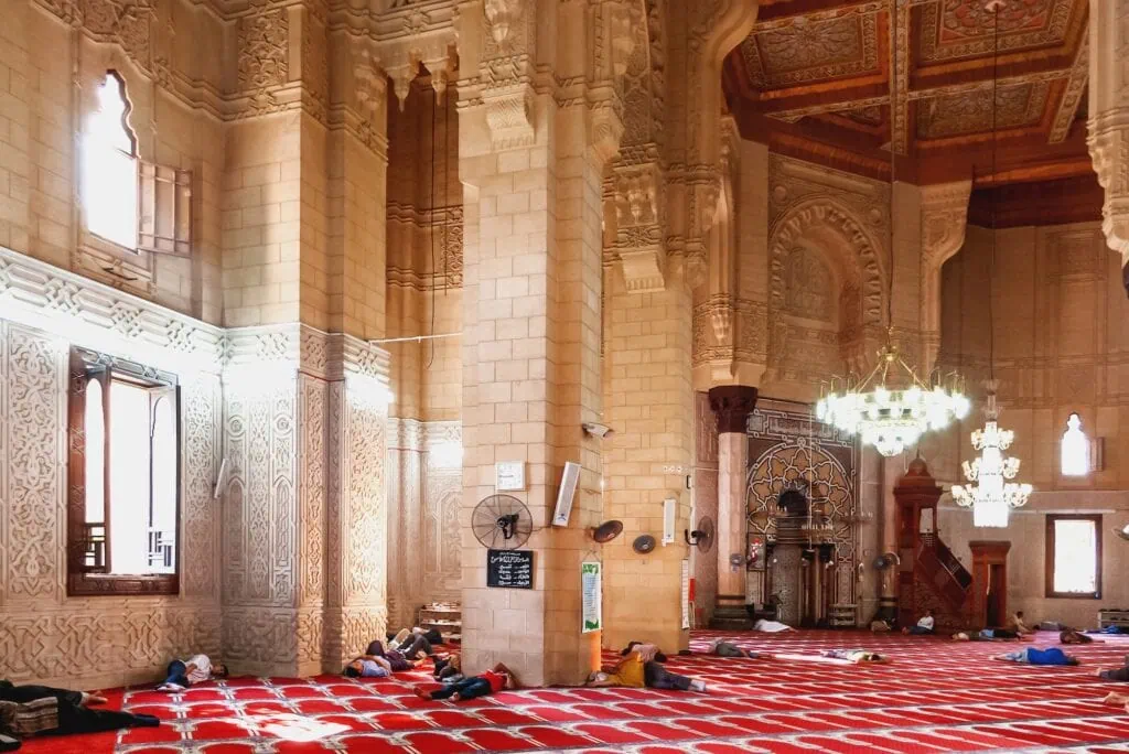 People resting on the floor inside Abu al-Abbas al-Mursi Mosque prayer hall, Alexandria