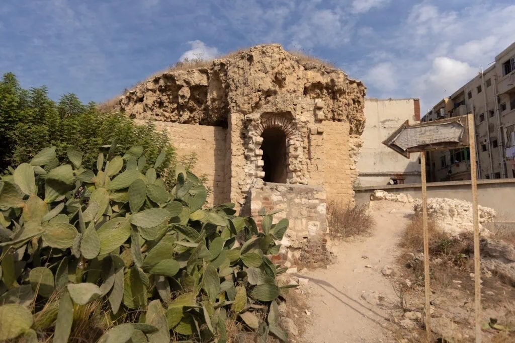 Exterior view of the entrance and surrounding stonework of the Catacombs of Kom El Shoqafa, Alexandria
