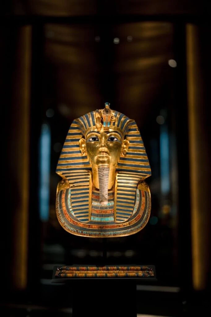 Close-up of Tutankhamun's golden funerary mask on display at the Grand Egyptian Museum (GEM) in Giza, Egypt — the 18th-dynasty boy king's death mask, made of solid 22-carat gold, dating to around 1323 BC