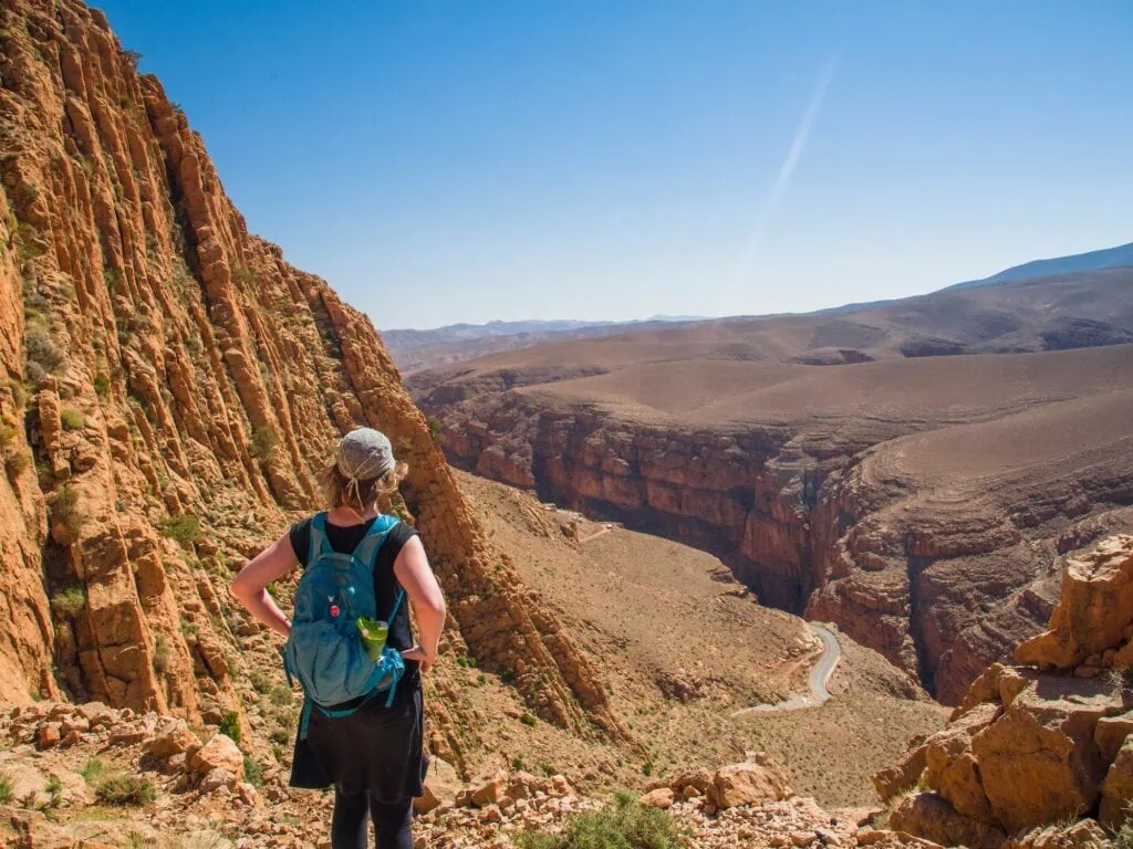 Hiker standing on a trail overlooking the Dades Gorges canyon in Dades Valley