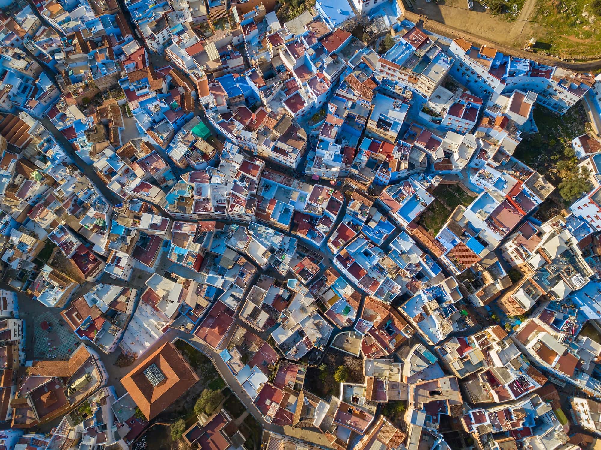 Aerial view of Chefchaouen's famous blue-painted medina buildings and winding streets