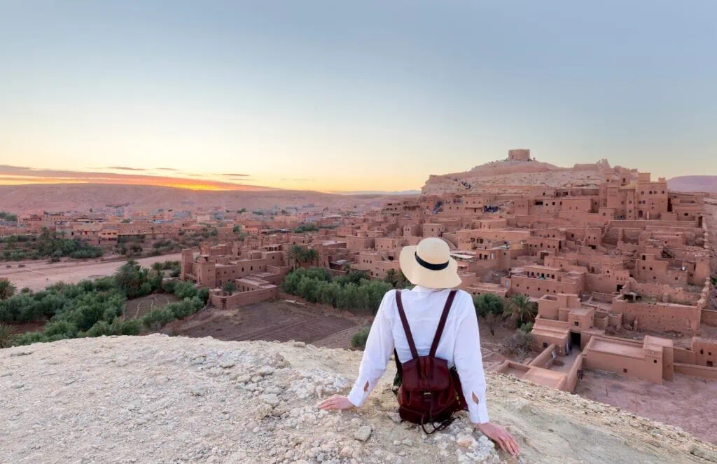 Ait Ben Haddou in the Atlas mountains of Morocco and woman tourist looking at the view