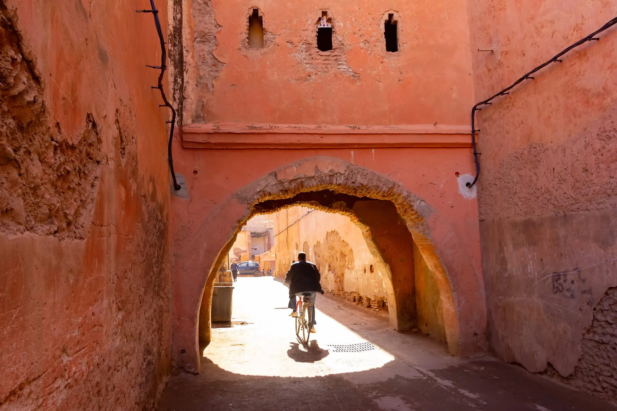 Traditional Moroccan architecture in Marrakech medina with red clay walls and arched passage