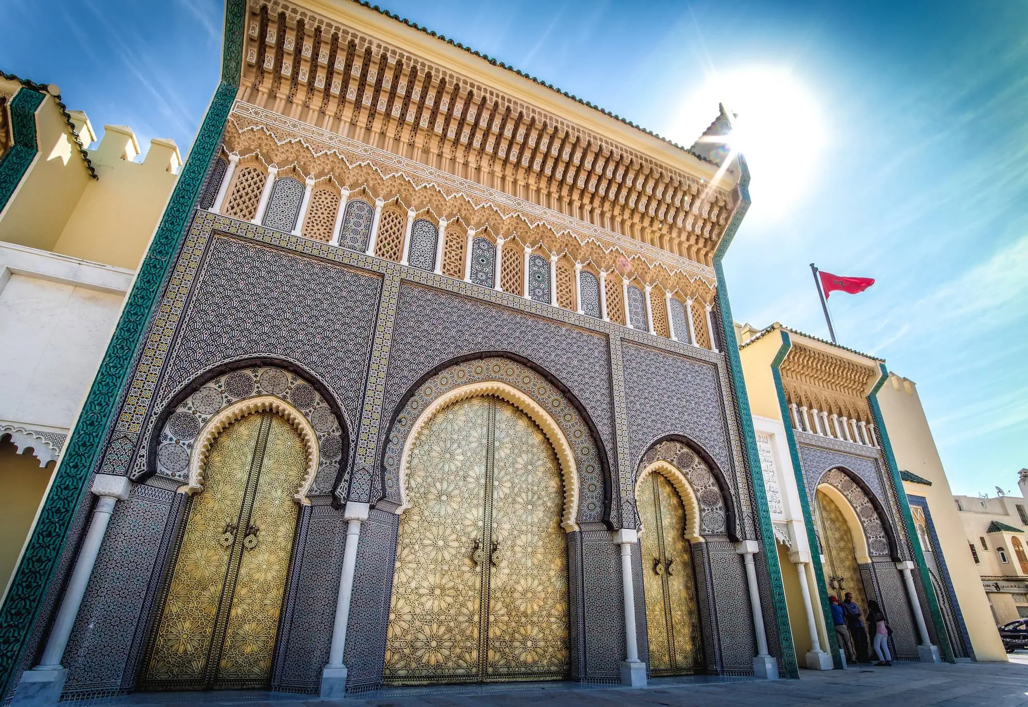 Ornate entrance gates of the Royal Palace in Fez showcasing intricate Moroccan Islamic architecture