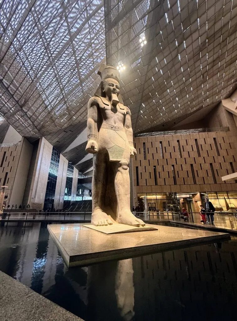 The colossal granite statue of Ramses II at the entrance hall of the Grand Egyptian Museum (GEM) in Giza, Egypt — 11 metres tall, 83 tonnes, originally erected at Memphis in the 13th century BC