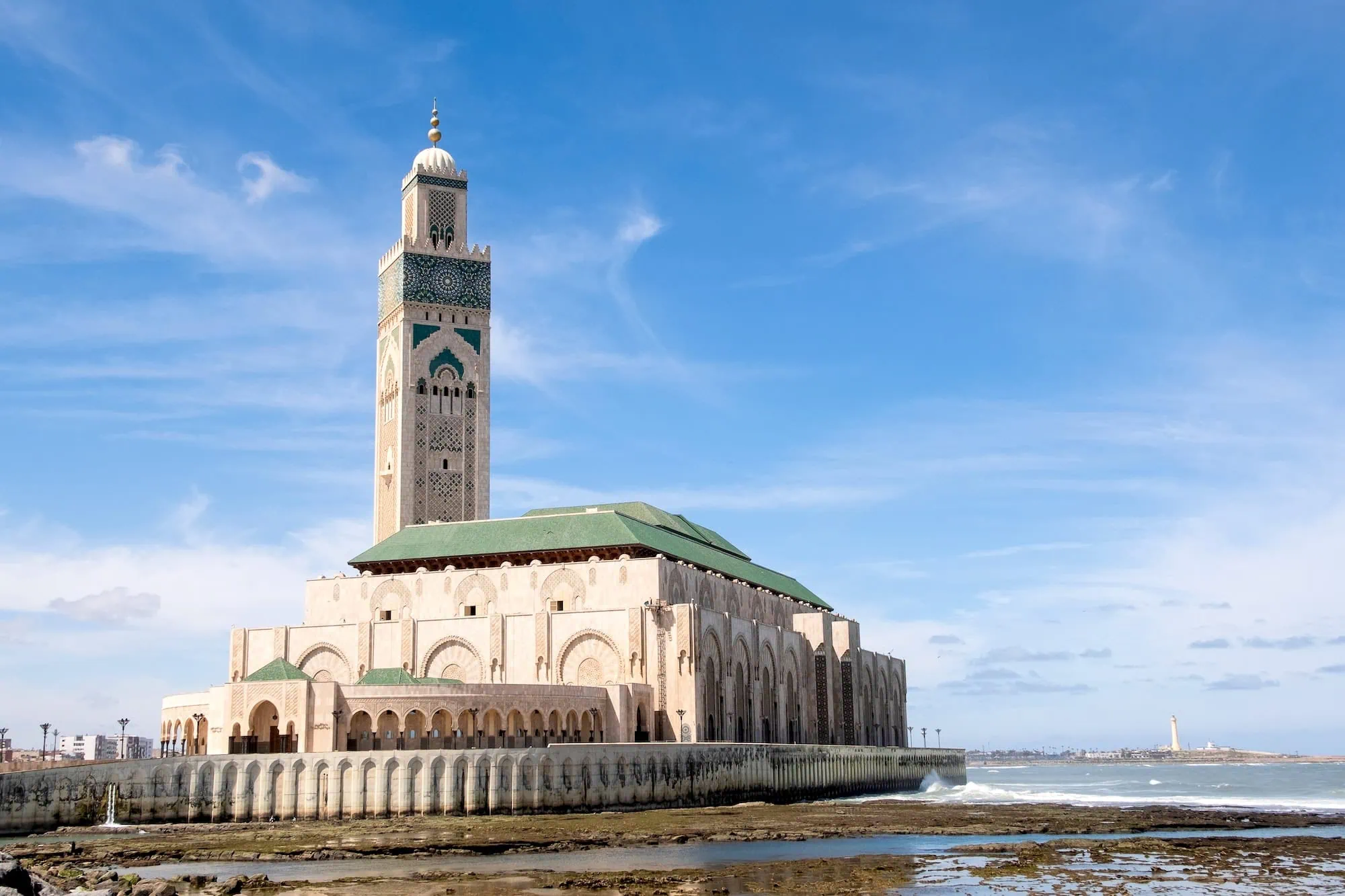 Hassan II Mosque with tall minaret viewed from Atlantic Ocean coastline