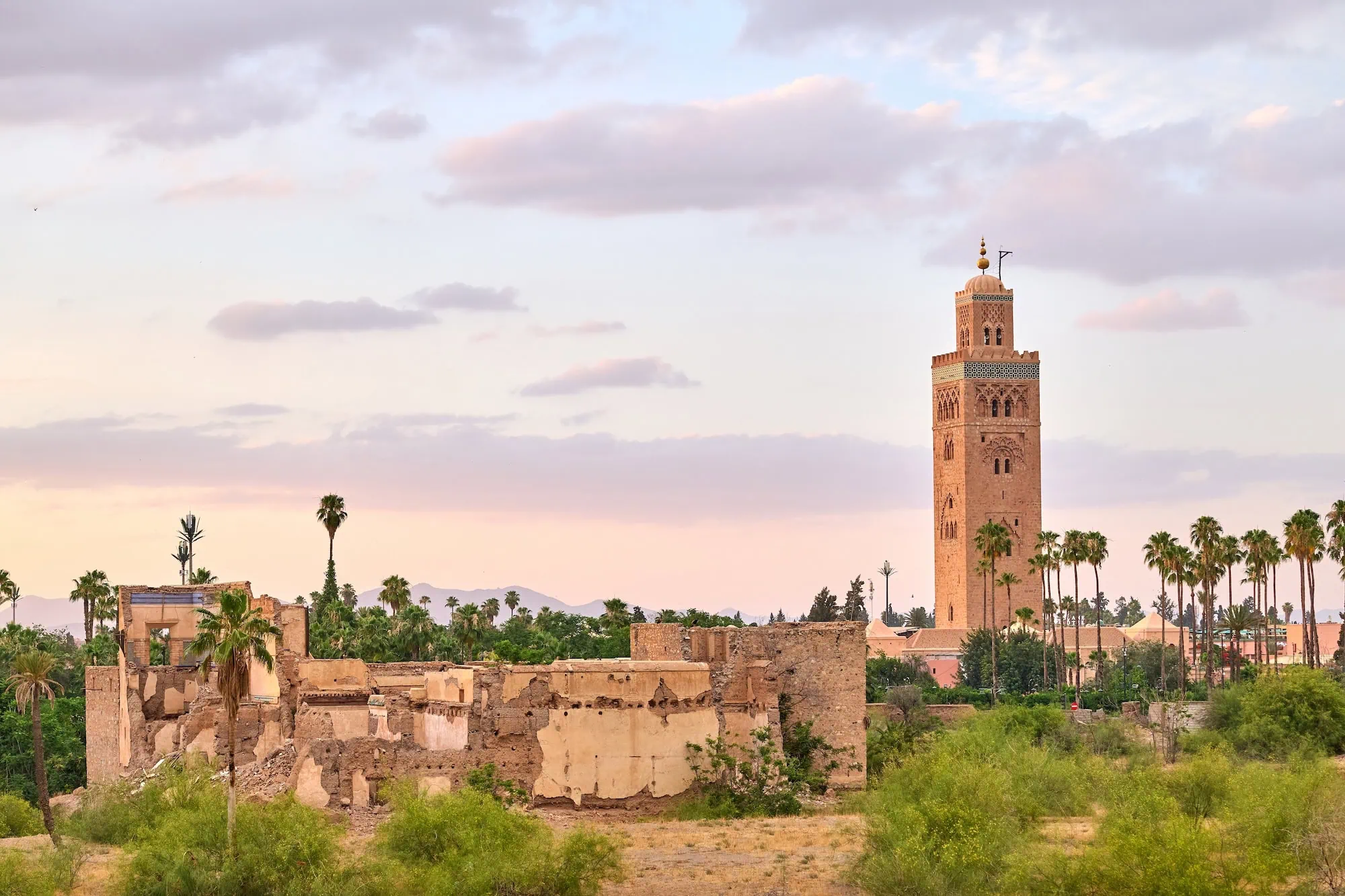 Koutoubia Mosque minaret in Marrakech during golden hour with surrounding architecture and vegetation