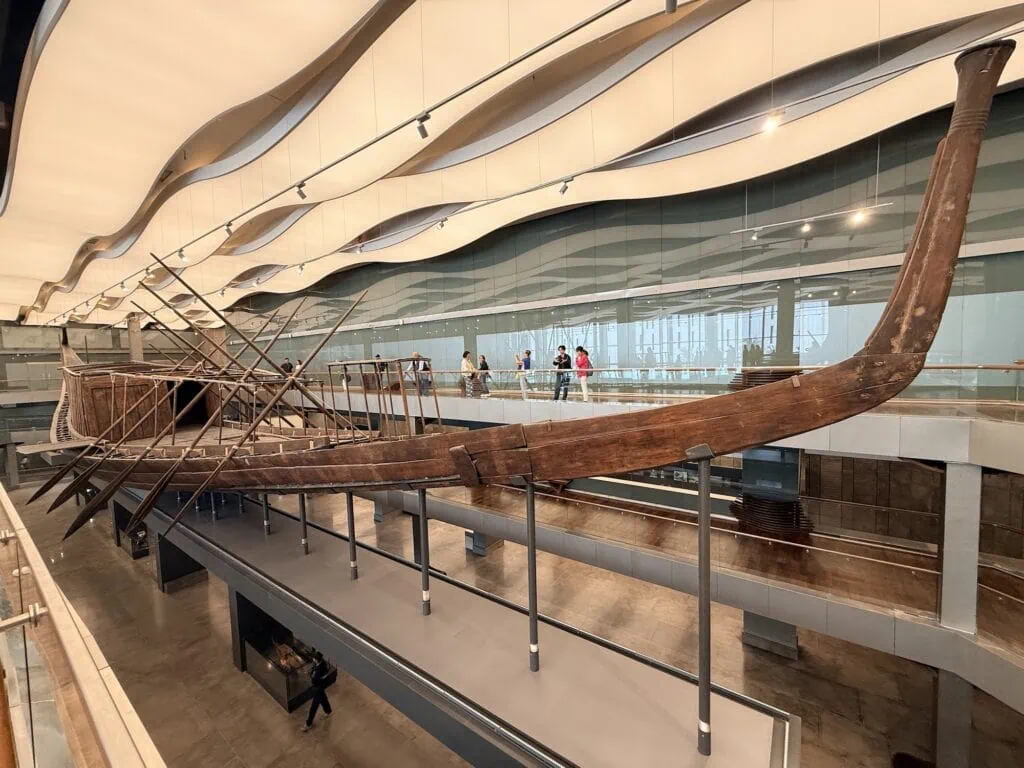 Khufu Solar Boat displayed in a dedicated gallery at the Grand Egyptian Museum, Giza