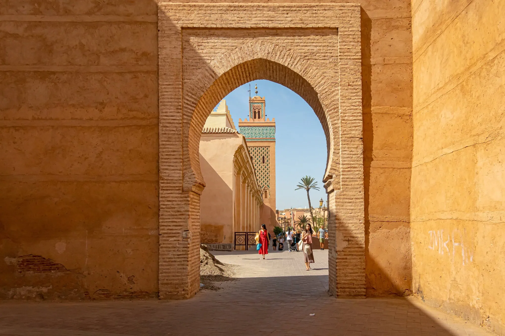 View through Moorish arch in Marrakech medina showing traditional Islamic architecture and courtyard