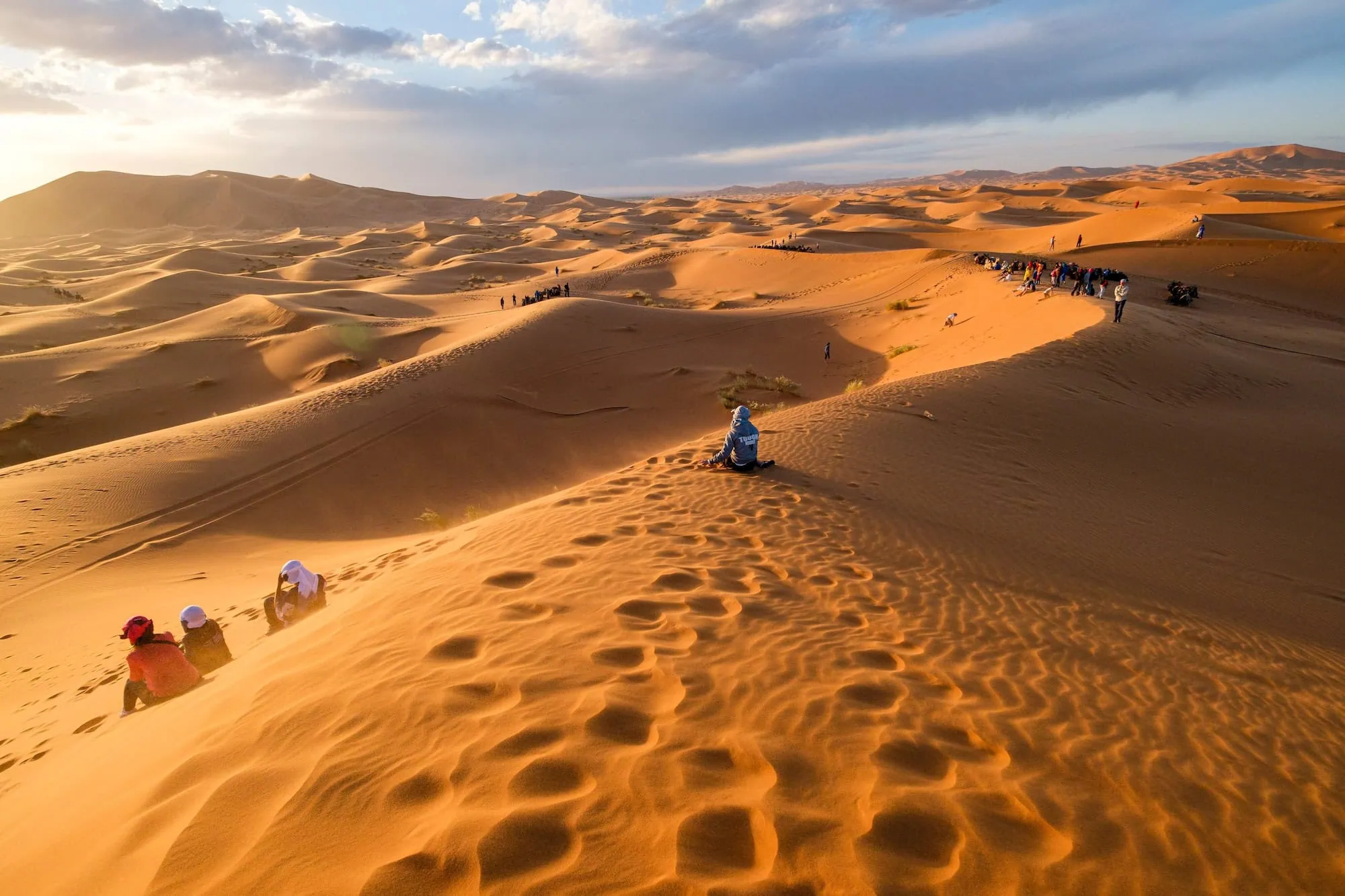 Tourists on camel trek in Erg Chebbi sand dunes, Sahara Desert, Morocco